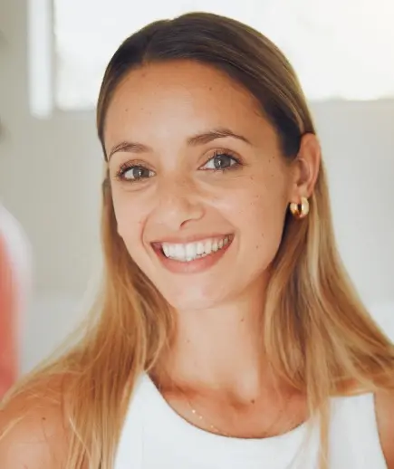 Smiling woman with healthy teeth in dental office setting.